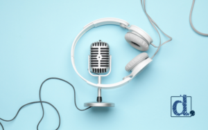 podcast microphone with white headphones, wires and light blue background